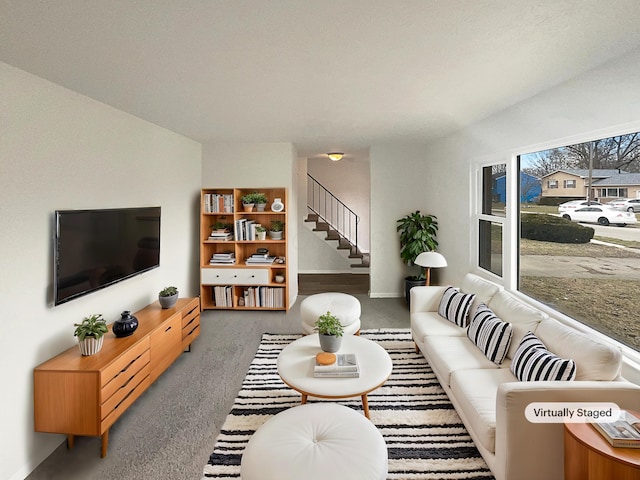 living room with carpet and stairway