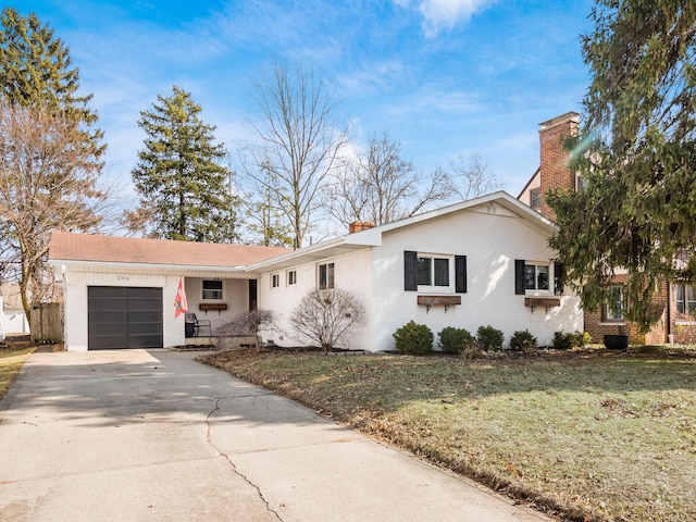 ranch-style house featuring an attached garage, driveway, a front lawn, and brick siding