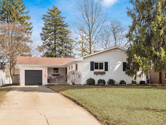 single story home with a front yard, brick siding, driveway, and an attached garage