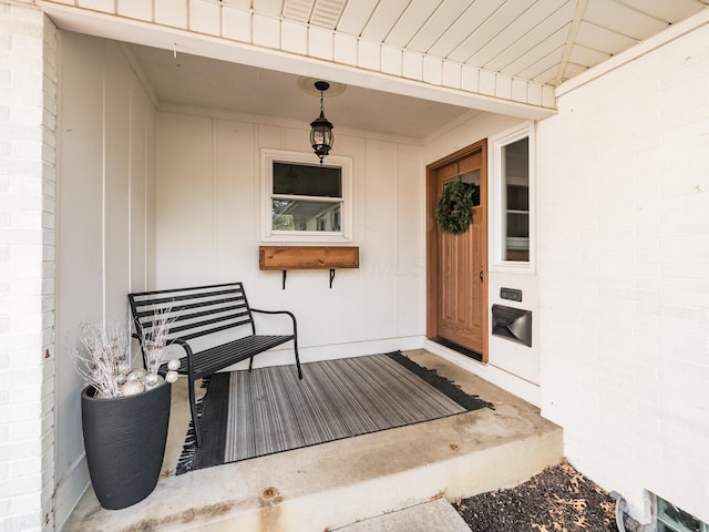 view of exterior entry featuring brick siding