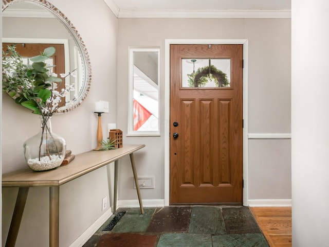 entrance foyer featuring crown molding, baseboards, and wood finished floors