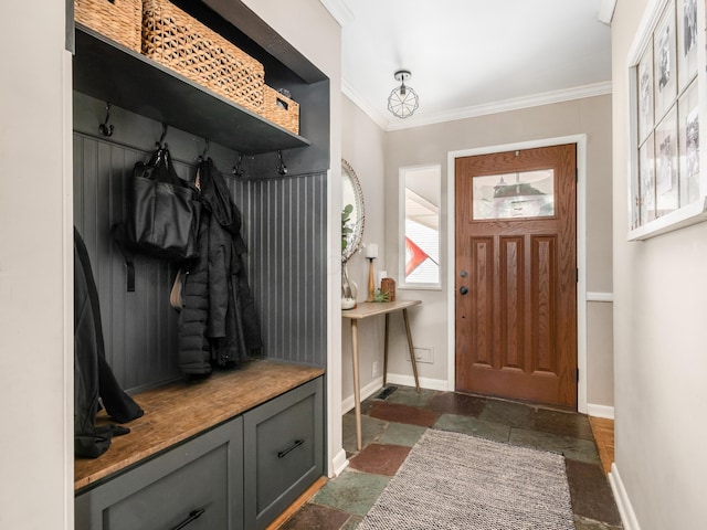 mudroom featuring ornamental molding, stone tile flooring, and baseboards