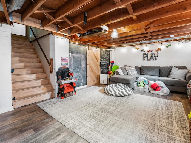 unfinished basement featuring stairway and wood finished floors