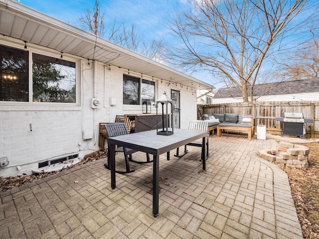 view of patio / terrace featuring an outdoor hangout area, a grill, and fence