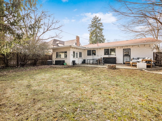 rear view of house with fence, an outdoor living space, and a lawn