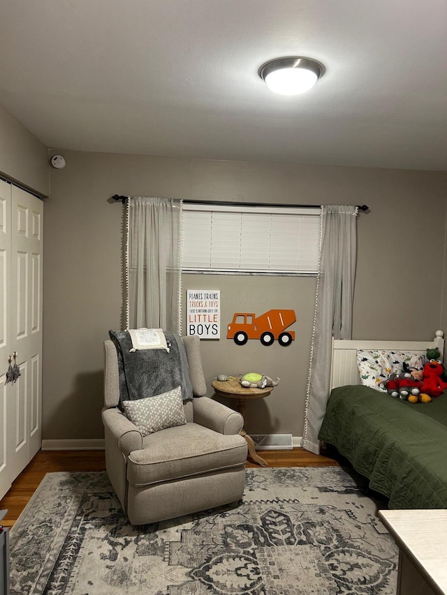 bedroom featuring baseboards and wood finished floors