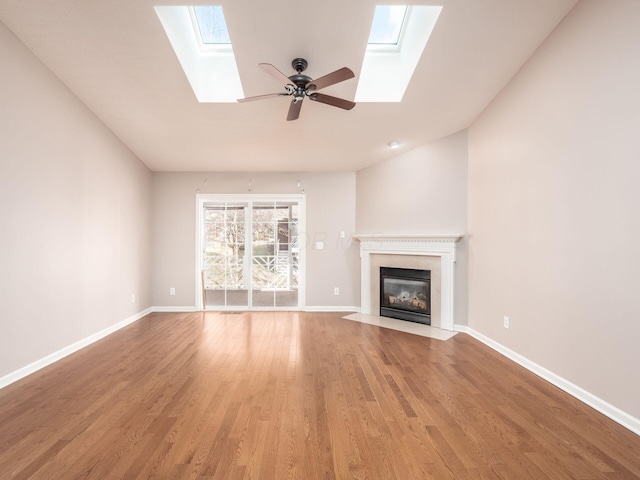 unfurnished living room with a fireplace with flush hearth, light wood-style flooring, and baseboards