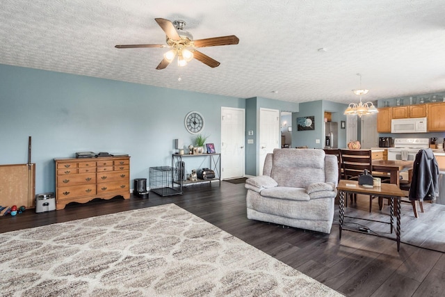 living room featuring a textured ceiling, dark wood-type flooring, and ceiling fan with notable chandelier