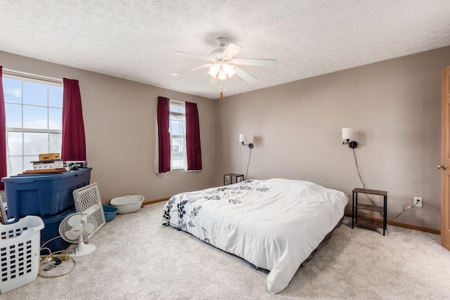 bedroom featuring a textured ceiling, carpet flooring, and baseboards