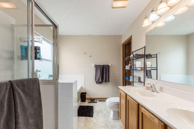 bathroom featuring double vanity, toilet, a washtub, a shower stall, and a sink