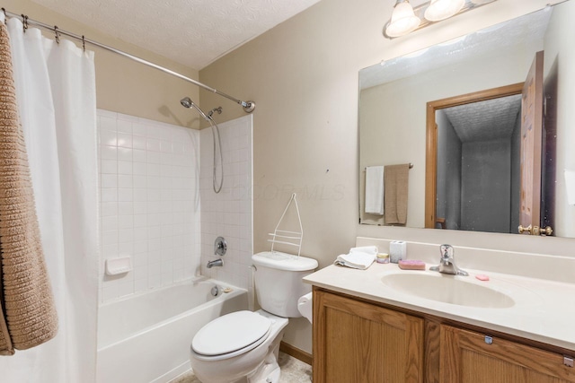 bathroom with a textured ceiling, shower / bath combo with shower curtain, vanity, and toilet