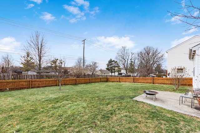 view of yard featuring a patio area, a fenced backyard, and a fire pit