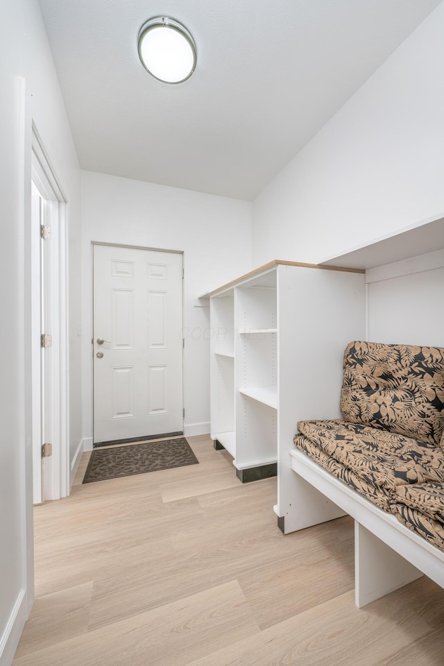 mudroom featuring light wood-style flooring and baseboards