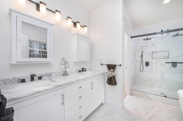 full bathroom featuring marble finish floor, double vanity, a sink, and a marble finish shower