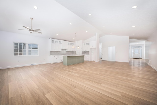 unfurnished living room featuring a ceiling fan, light wood-type flooring, baseboards, and recessed lighting