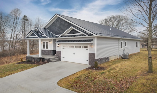 craftsman inspired home featuring concrete driveway, metal roof, an attached garage, covered porch, and a front yard