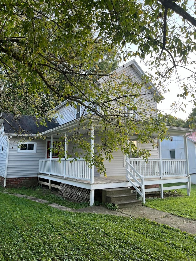 view of front of property with covered porch and a front yard