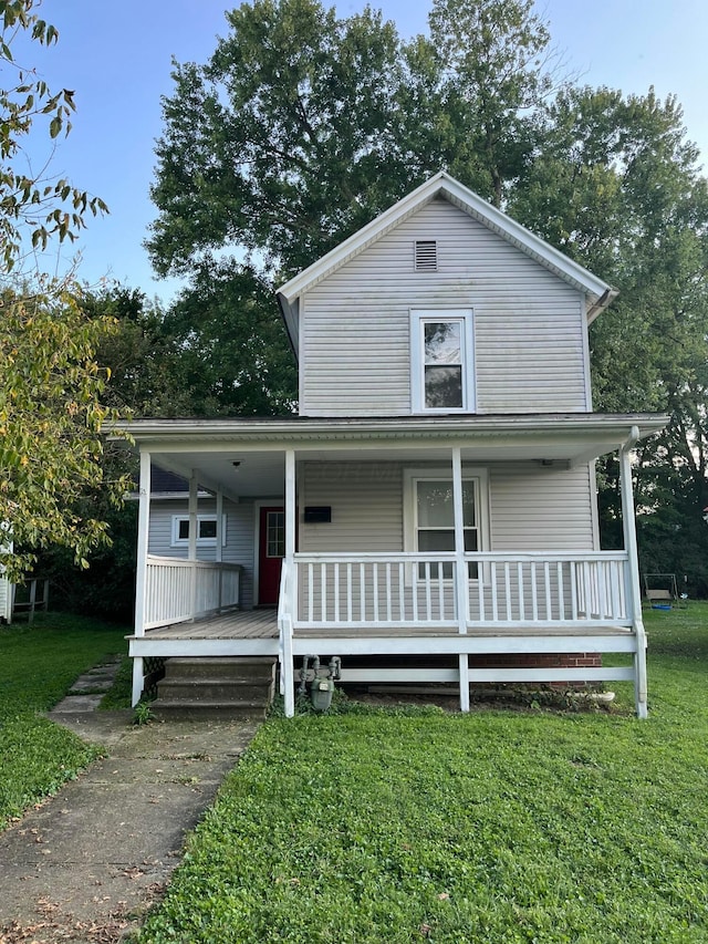 view of front facade with a porch and a front lawn