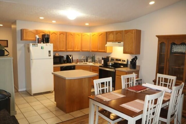 kitchen with stainless steel electric range oven, freestanding refrigerator, a kitchen island, a sink, and under cabinet range hood