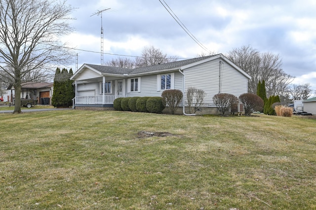 single story home with a garage and a front lawn