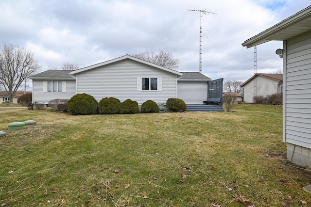 view of side of property with a yard