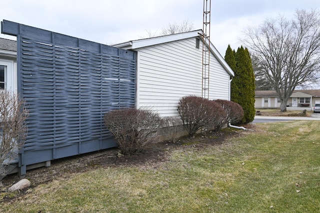 view of side of home featuring a yard