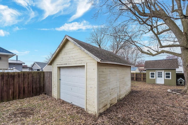 detached garage featuring fence