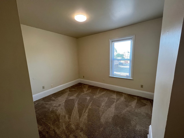 carpeted empty room with baseboards