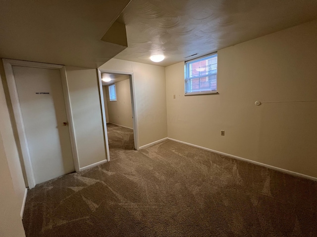 basement with baseboards and carpet flooring