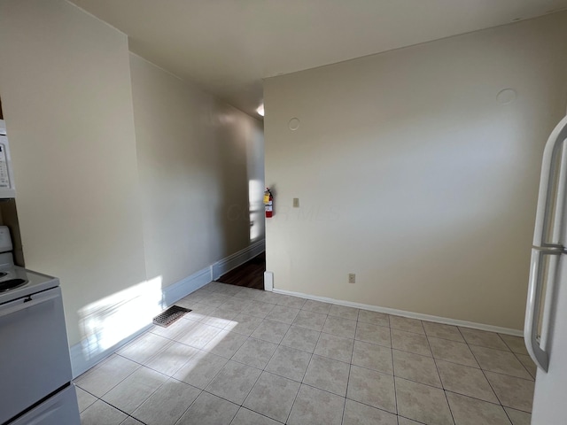 interior space with light tile patterned floors, visible vents, and baseboards