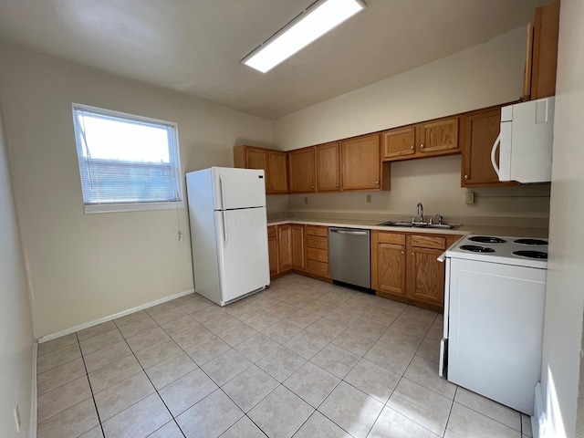 kitchen featuring brown cabinets, white appliances, light countertops, and a sink