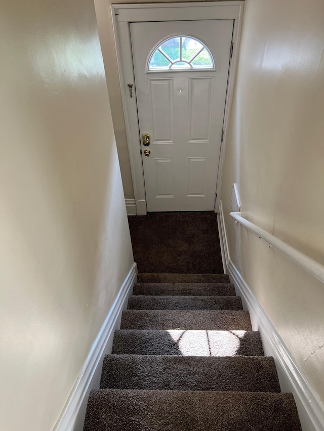 stairway featuring baseboards