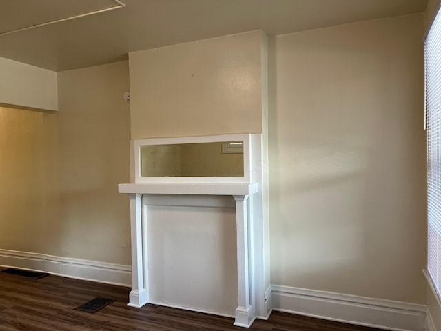 interior details with wood finished floors, visible vents, and baseboards