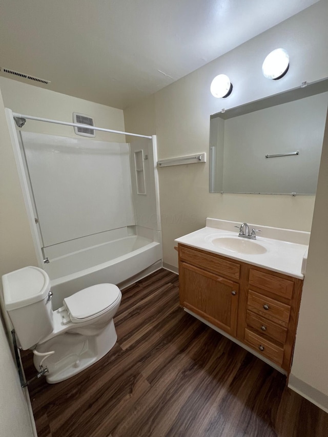 full bath featuring visible vents, vanity, toilet, and wood finished floors