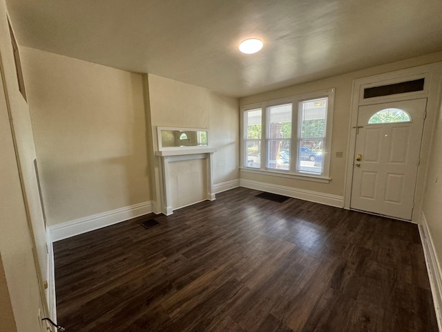 entryway with visible vents, baseboards, and dark wood-style flooring