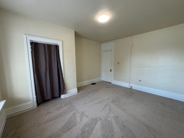 unfurnished bedroom featuring carpet floors and baseboards