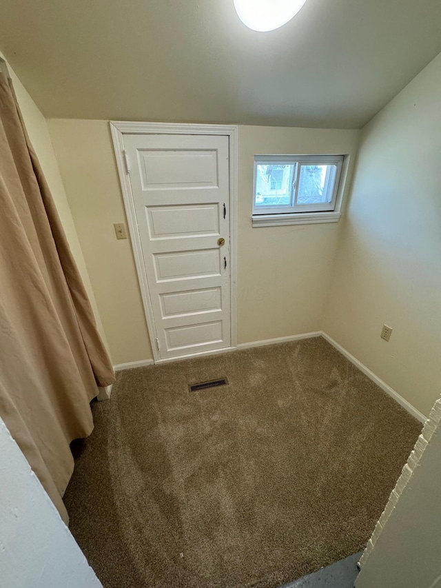 interior space with carpet floors, visible vents, and baseboards