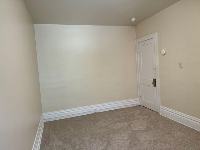 carpeted empty room with baseboards