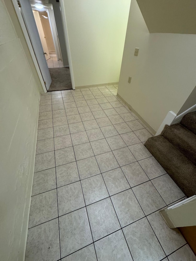 interior space featuring stairway and light tile patterned flooring