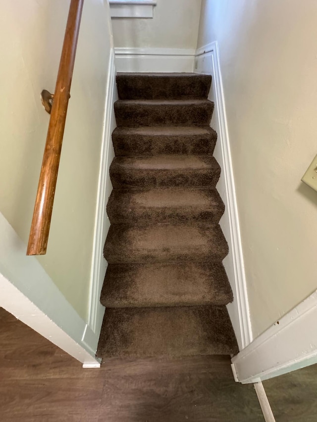 stairway featuring wood finished floors