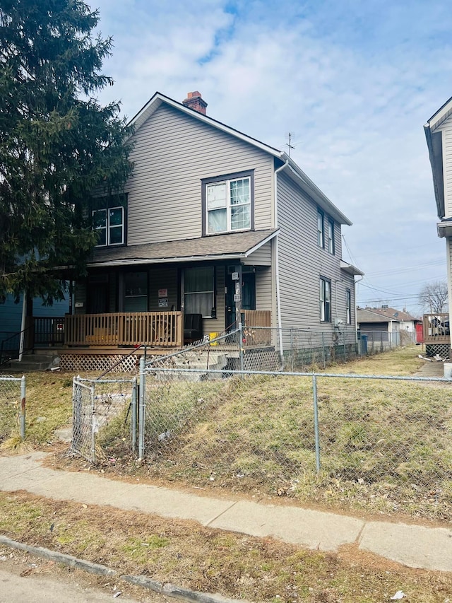 view of front of house featuring covered porch, a fenced front yard, and a chimney