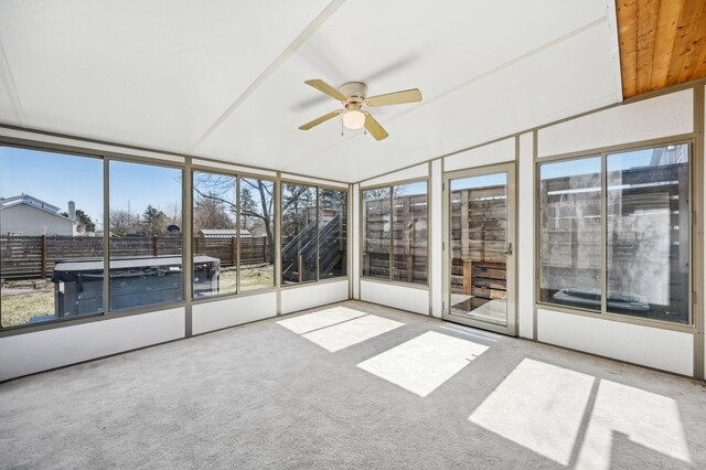 unfurnished sunroom featuring a ceiling fan and vaulted ceiling