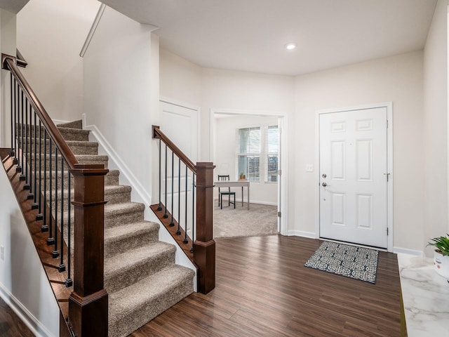 foyer with stairs, baseboards, dark wood-style flooring, and recessed lighting