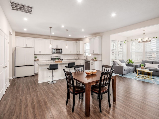 dining area featuring visible vents, dark wood-type flooring, and recessed lighting