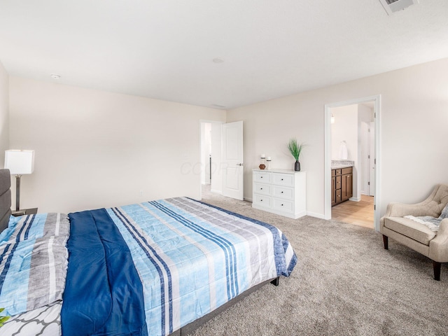 bedroom with light carpet, visible vents, and baseboards