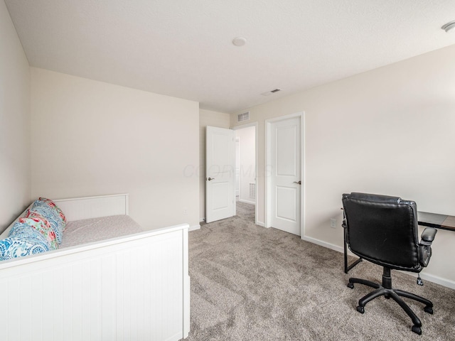 bedroom with carpet floors, visible vents, and baseboards