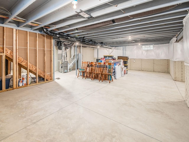 basement featuring water heater and heating unit