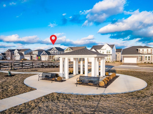 view of home's community featuring a residential view and fence