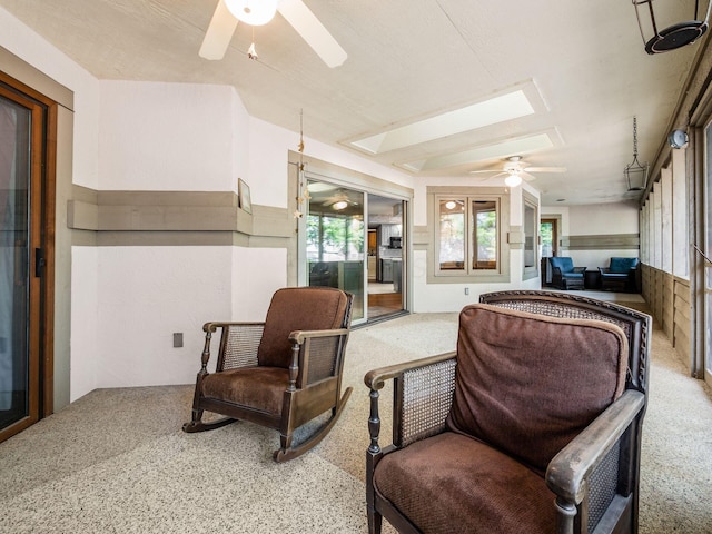 interior space featuring ceiling fan and carpet flooring