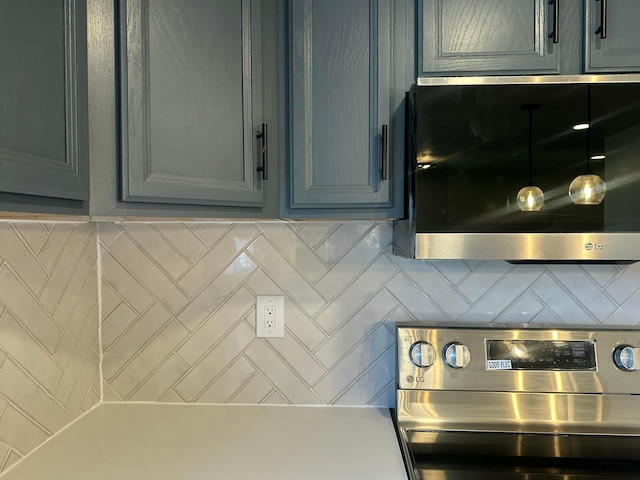 kitchen featuring tasteful backsplash, gray cabinets, stainless steel range with electric cooktop, and light countertops